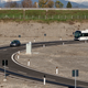Photo of an electric car and electric bus on a wireless charging road